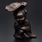 Bronze Figurine With Lotus Leaf