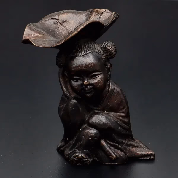 Bronze Figurine With Lotus Leaf